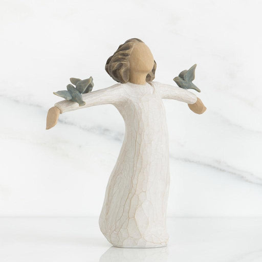 Decorative figurine of a woman with outstretched arms holding birds on a white background