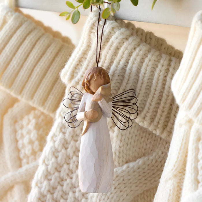 Wooden angel ornament hanging on a knitted blanket