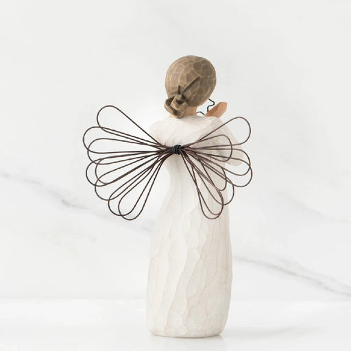 A serene angel made of willow branches, cradling a heart, representing love and tranquility in nature.