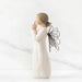 A willow tree angel with a heart, embodying themes of love and peace in a natural environment.