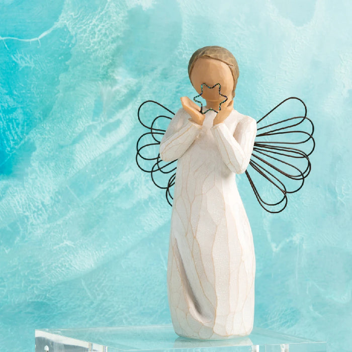 A willow angel figure with a heart, conveying messages of love and calmness amidst a natural backdrop.