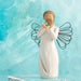 A willow angel figure with a heart, conveying messages of love and calmness amidst a natural backdrop.