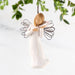 A willow tree angel gently holds a bird, embodying a peaceful and harmonious connection with nature.
