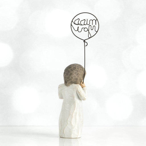Statue of a woman holding a balloon with 'miss you' written on it against a white background