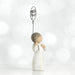 Decorative angel figurine holding a heart-shaped balloon with 'miss you' on a white background