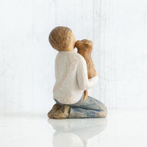 Figurine of a child holding a dog on a white background