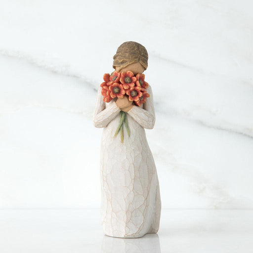 Statue of a woman holding flowers against a white background