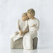 Statue of two people granddaughter and grandmother sitting together on a white background