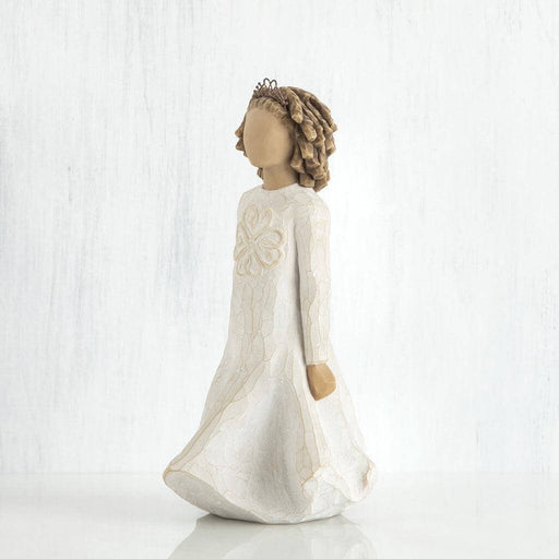 Statue of a woman in a long white dress with floral headpiece on a white background