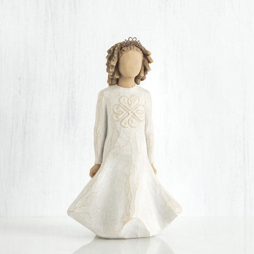 Decorative figurine of a girl in a white dress with a heart design on a white background