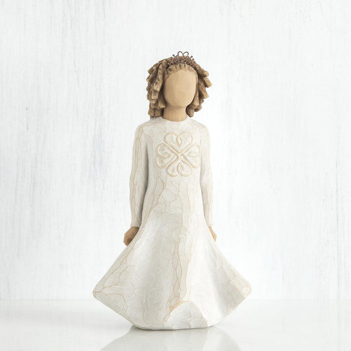 Decorative figurine of a girl in a white dress with a heart design on a white background