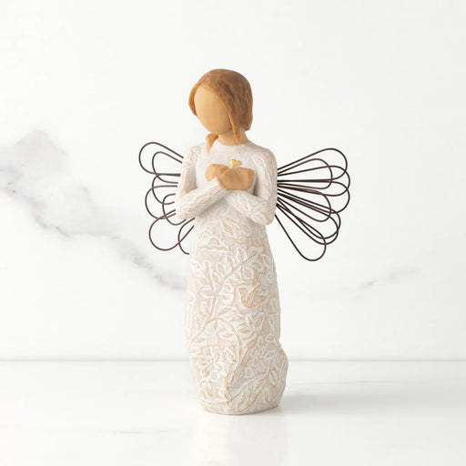 Angel figurine with wings on a white background
