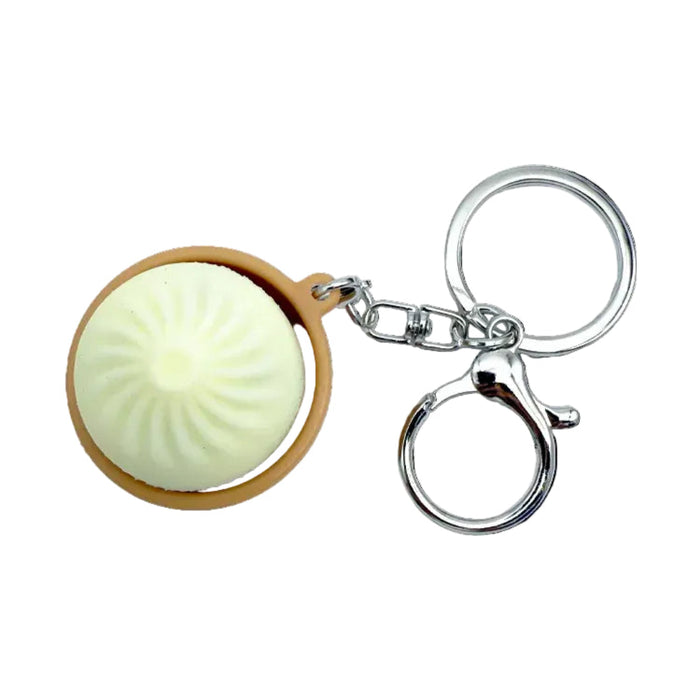 Keychain with a round, light-colored object inside a wooden-like casing on a white background