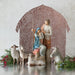 Nativity scene with Mary, Joseph, and baby Jesus under a patterned canopy.