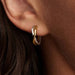 These Pandora Organically Shaped Two-tone Open Hoop Earrings blend artistry with everyday elegance.