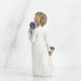Statue of a person holding blue flowers against a white background