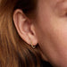 PANDORA Beaded Huggie Earrings in 14k gold plating with delicate bead detailing and a sparkling center stone