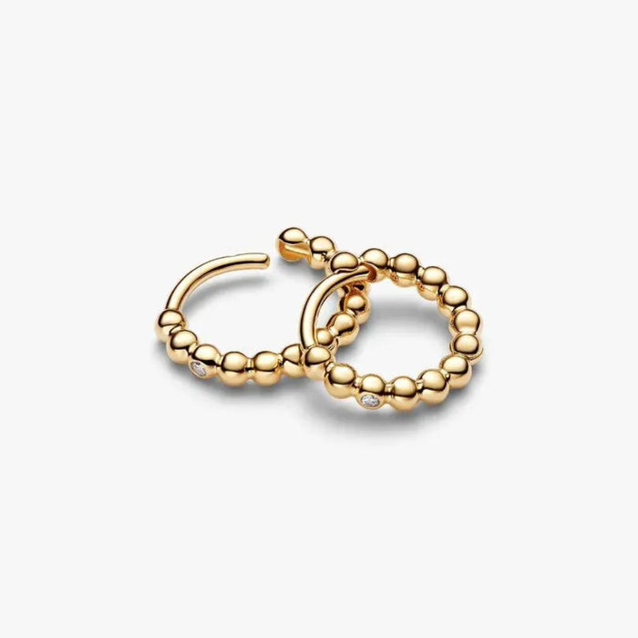 PANDORA Beaded Huggie Earrings in 14k gold plating with delicate bead detailing and a sparkling center stone