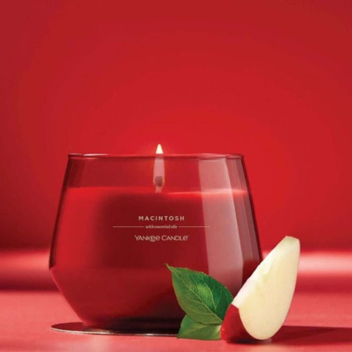Red candle with 'Macintosh' scent from Yankee Candle on a red background