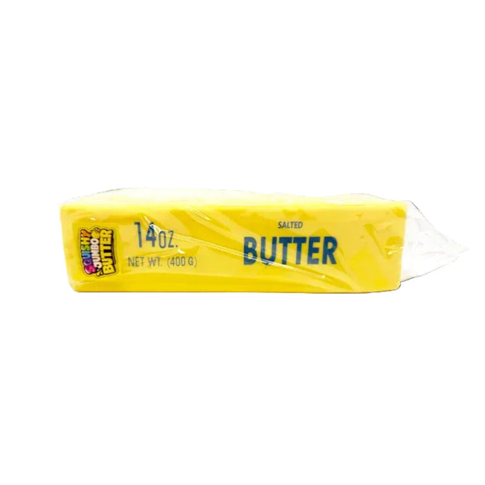Butter stick with yellow wrapper on a white background