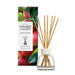 Yankee Candle Macintosh reed diffuser with a clear glass bottle, white cap, and natural bamboo reeds, shown next to its colorful apple-themed packaging box on a white background.