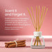 Yankee Candle reed diffuser with natural wood reeds in a clear glass bottle, shown beside a small bundle of cinnamon sticks on a pink background with promotional text.