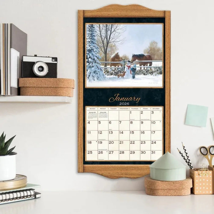 Calendar with a winter scene and January 2026 display on a wall shelf.