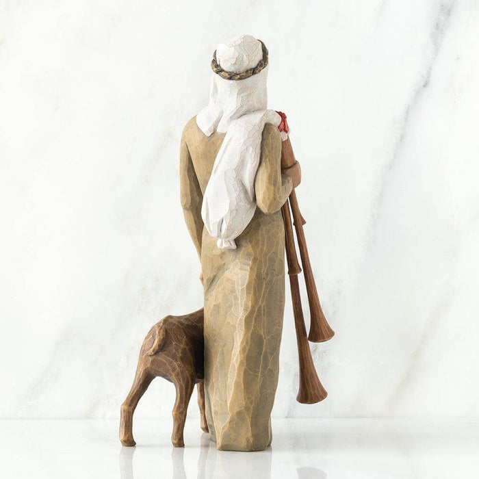 Wooden figurine of a shepherd with a dog and two shepherd's crooks on a white background