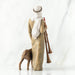 Wooden figurine of a shepherd with a dog and two shepherd's crooks on a white background