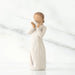 White  figurine of a woman holding a heart on a white background