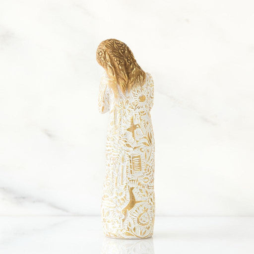 Decorative bottle with gold and white pattern on a white background
