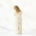 Decorative bottle with gold and white pattern on a white background