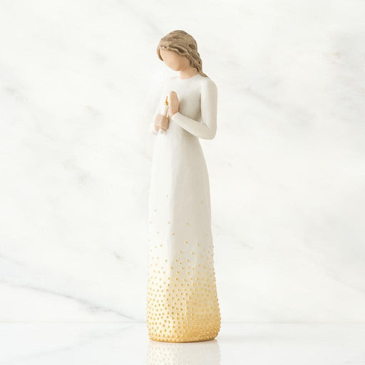 White figurine with a candle  with a gold base on a white background