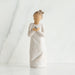 Decorative angel figurine holding a baby bird  on a white background