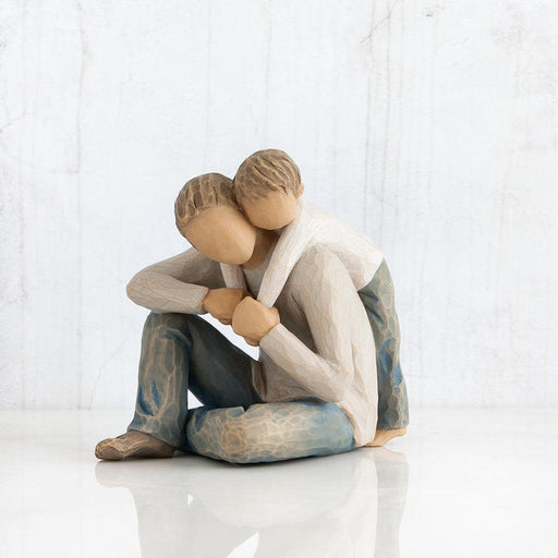 figurine of Father and son  embracing on a white background