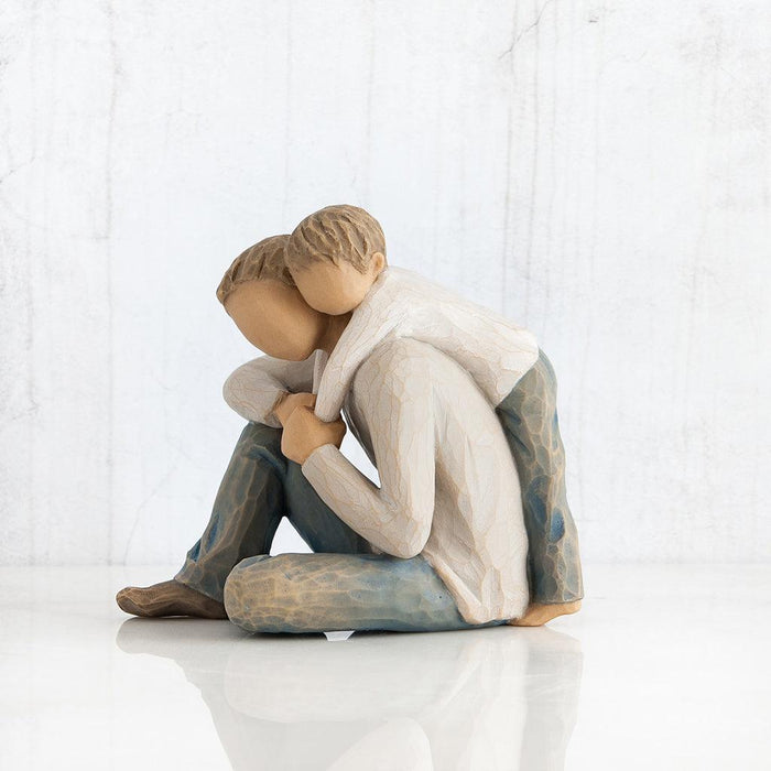 figurine of Father and son  embracing on a white background