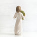  figurine of a woman holding leaves on a white background
