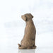 Brown ceramic dog sculpture on a white background
