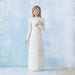 White figurine of a woman holding a Dove  against a light blue background