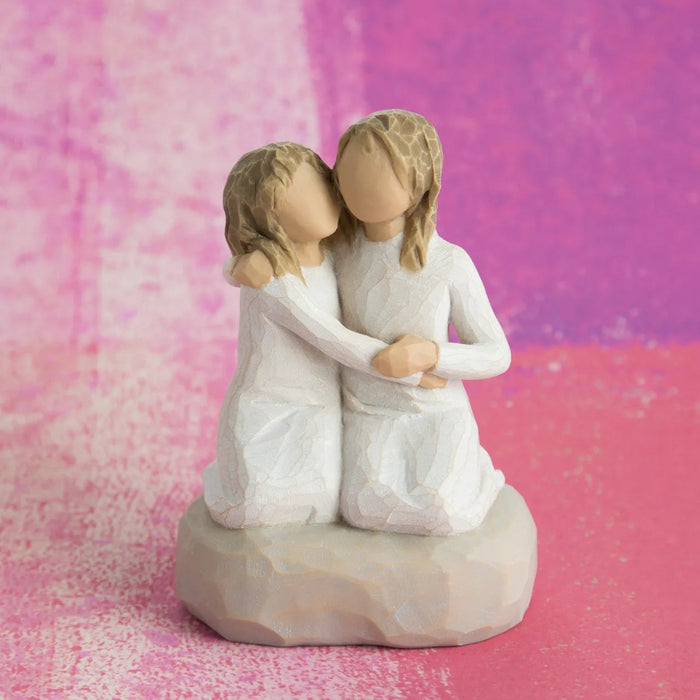 Willow Tree Sister Mine figurine showing two sisters sitting together
pink chock background  