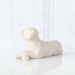 White dog figurine on a light gray background