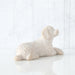 White sculpture of a lying dog on a white background