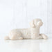 White ceramic dog figurine on a white background