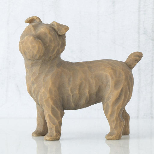 Brown ceramic dog sculpture on a white background