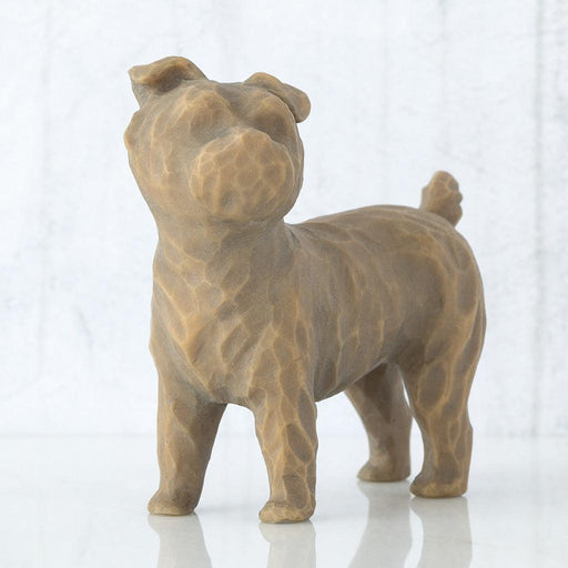 Brown ceramic dog figurine on a white background