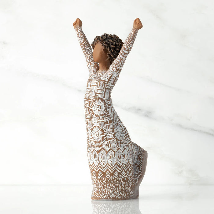 A woman figurine with arms extended upward, conveying a sense of triumph or excitement.