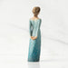 Figurine of a woman in a blue dress with gold accents on a white background