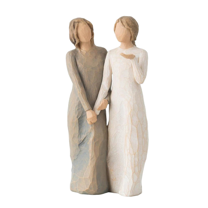 Two figurines holding hands on a white background
