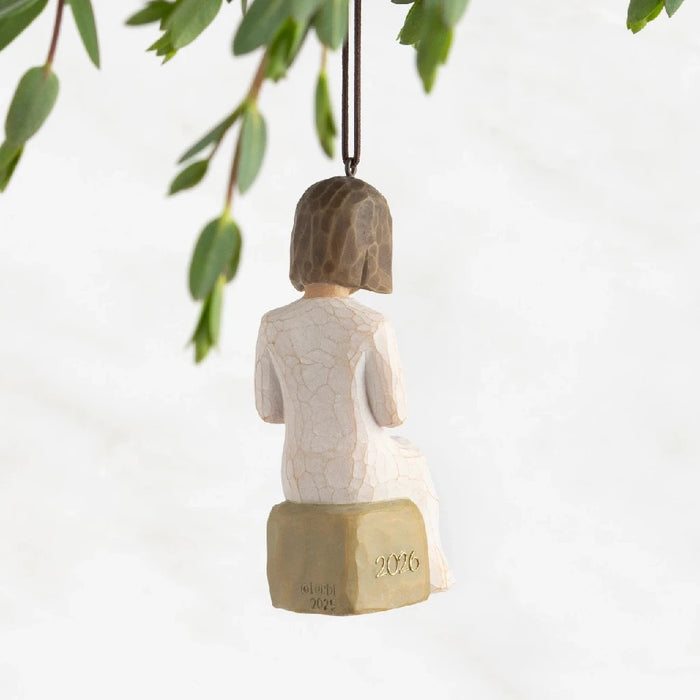 An ornament featuring a girl reading beneath a willow tree, capturing a peaceful and enchanting moment in nature.