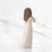 A charming figurine of a woman wearing a white dress, capturing her elegance and the fine craftsmanship of the piece.
